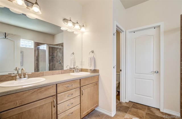 418 Hilltop Cir, Colorado Springs, CO 80905 - full bathroom with a stall shower, double vanity, and tile patterned floors