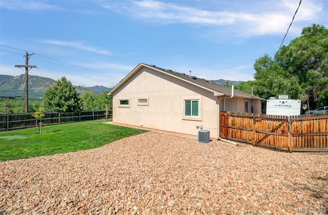 418 Hilltop Cir, Colorado Springs, CO 80905 - rear view of house featuring a mountain view, stucco siding, and a fenced backyard
