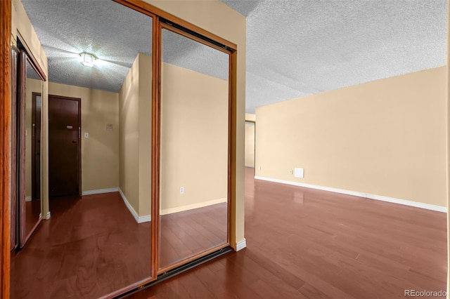 2 Adams St Unit 1507, Denver, CO 80206 - corridor featuring wood finished floors, a textured ceiling, and baseboards