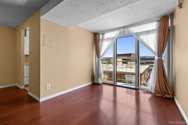 2 Adams St Unit 1507, Denver, CO 80206 - spare room with wood finished floors, baseboards, and a textured ceiling