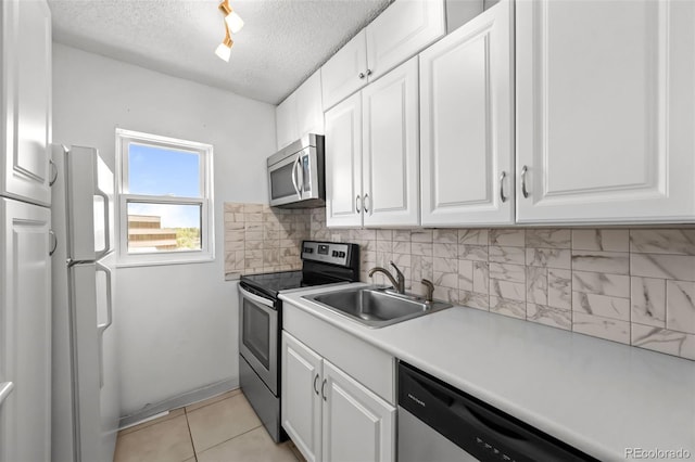2 Adams St Unit 1507, Denver, CO 80206 - kitchen with stainless steel appliances, a sink, white cabinets, and a textured ceiling