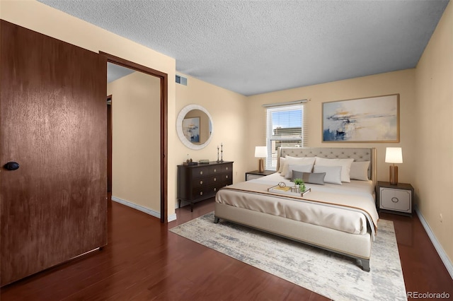 2 Adams St Unit 1507, Denver, CO 80206 - bedroom featuring wood finished floors, a textured ceiling, and baseboards