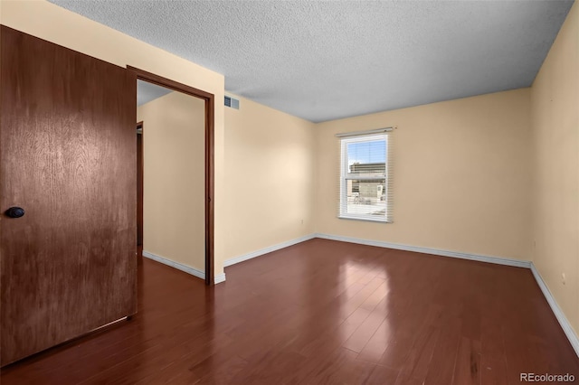 2 Adams St Unit 1507, Denver, CO 80206 - empty room featuring a textured ceiling, wood finished floors, and baseboards
