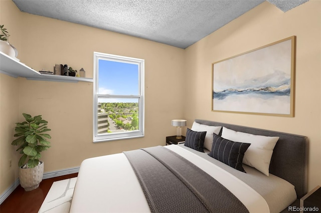 2 Adams St Unit 1507, Denver, CO 80206 - bedroom with wood finished floors, a textured ceiling, and baseboards