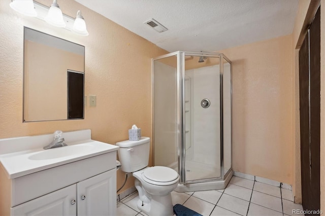 bathroom with an enclosed shower, vanity, tile patterned floors, and a textured ceiling