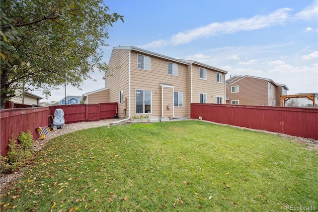 rear view of property featuring a yard