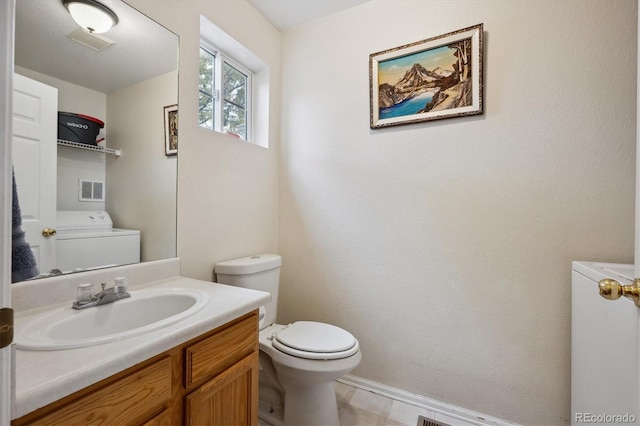 bathroom with toilet, washer / clothes dryer, and vanity