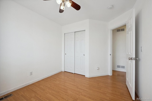 unfurnished bedroom with ceiling fan, a closet, and light hardwood / wood-style flooring