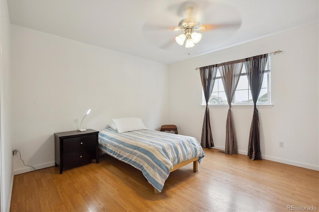 bedroom with ceiling fan and light wood-type flooring