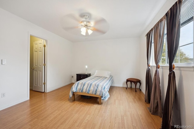 bedroom with ceiling fan and light hardwood / wood-style flooring