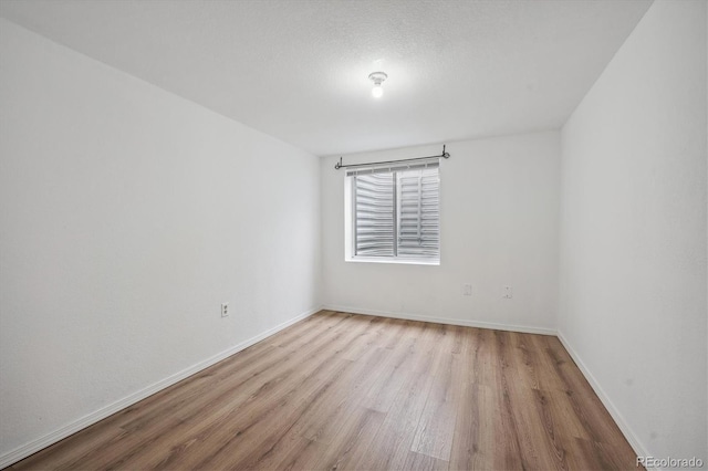 spare room featuring light hardwood / wood-style flooring