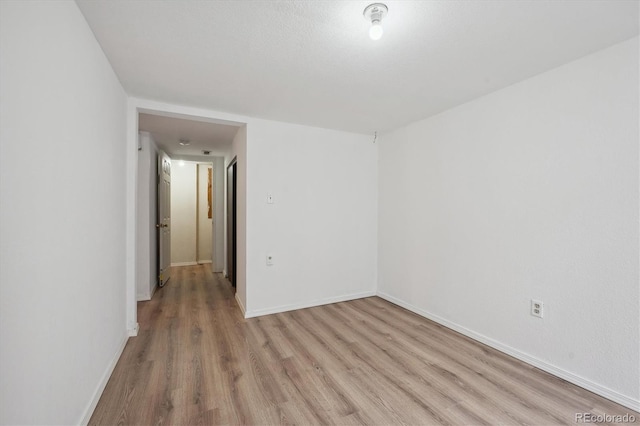 unfurnished room with light wood-type flooring