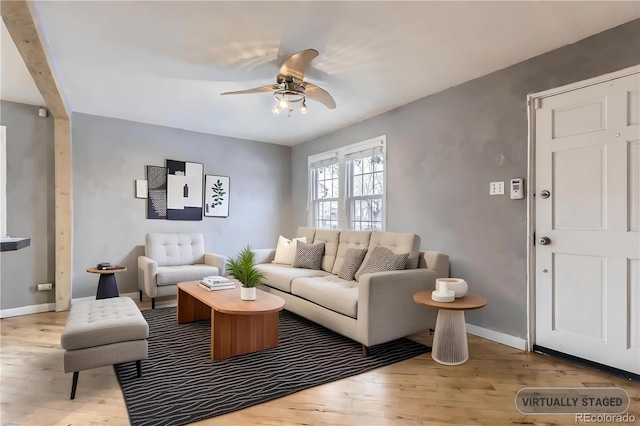 living room featuring ceiling fan and light hardwood / wood-style floors