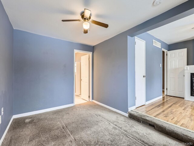 carpeted empty room with ceiling fan