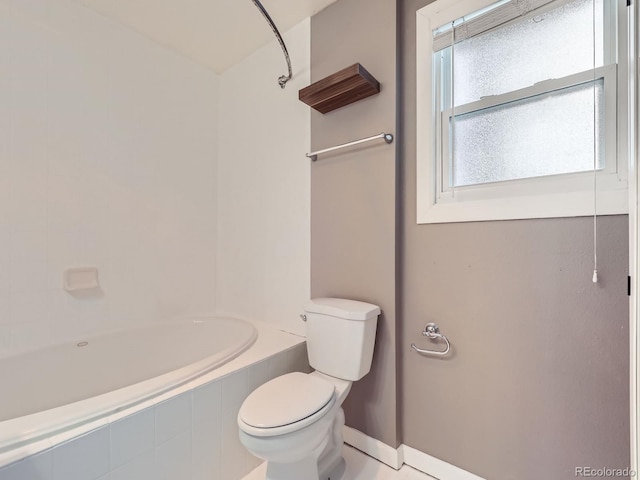 bathroom featuring tiled shower / bath and toilet