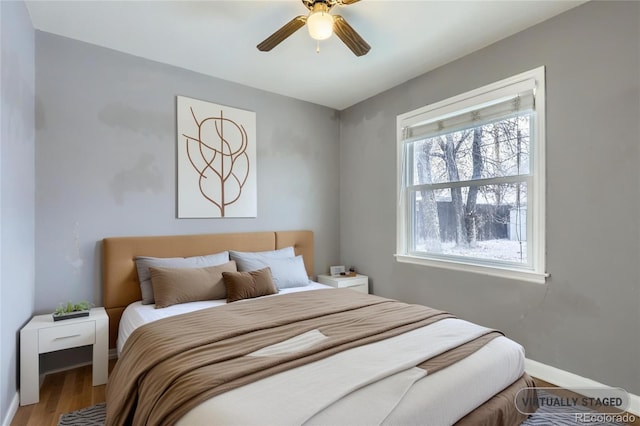 bedroom featuring hardwood / wood-style flooring and ceiling fan