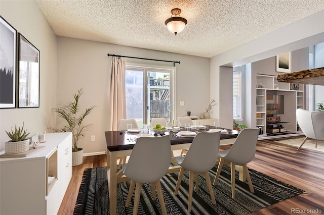8750 Redwing Ave, Littleton, CO 80126 - dining space featuring wood finished floors and a textured ceiling