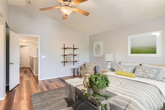 8750 Redwing Ave, Littleton, CO 80126 - bedroom featuring lofted ceiling, a textured ceiling, wood finished floors, baseboards, and ceiling fan