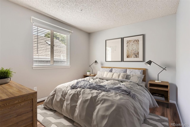 8750 Redwing Ave, Littleton, CO 80126 - bedroom featuring wood finished floors, a textured ceiling, and baseboards