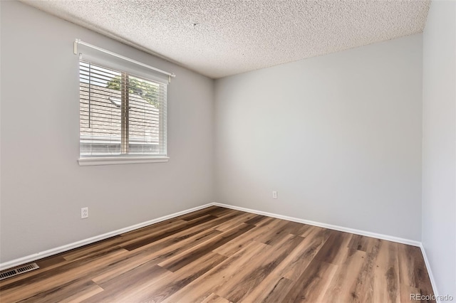 8750 Redwing Ave, Littleton, CO 80126 - spare room featuring wood finished floors, a textured ceiling, and baseboards