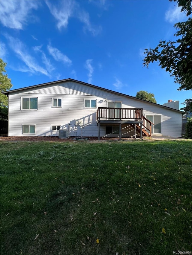 back of house with a deck and a lawn