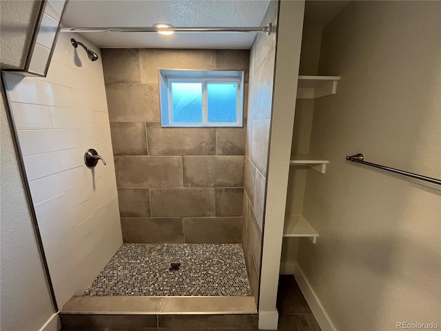 15908 E Flora Pl, Aurora, CO 80013 - full bathroom featuring a tile shower and baseboards