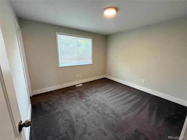 15908 E Flora Pl, Aurora, CO 80013 - spare room with dark carpet and baseboards