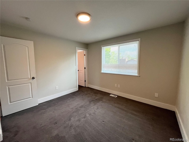 15908 E Flora Pl, Aurora, CO 80013 - unfurnished bedroom featuring dark carpet and baseboards