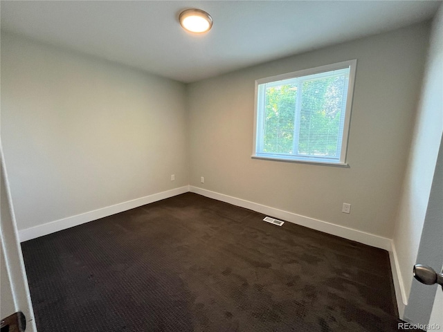 15908 E Flora Pl, Aurora, CO 80013 - spare room with baseboards and dark colored carpet
