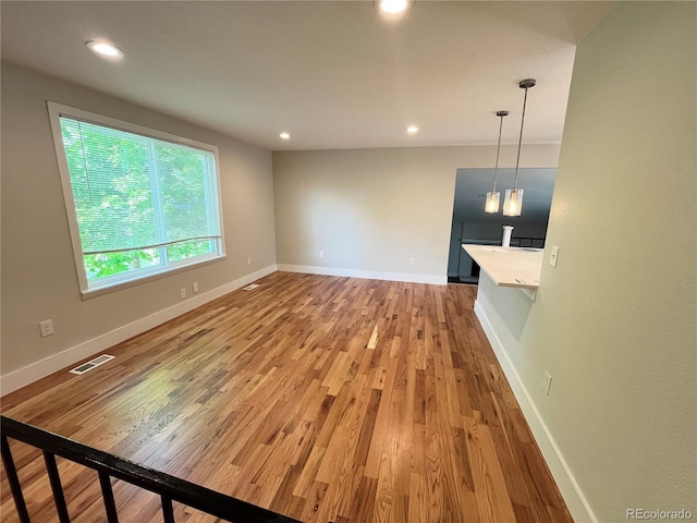 15908 E Flora Pl, Aurora, CO 80013 - unfurnished living room with light wood-style flooring, recessed lighting, and baseboards