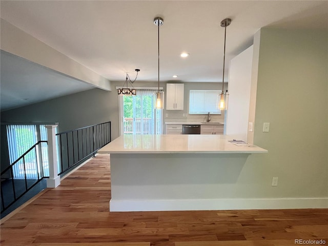 15908 E Flora Pl, Aurora, CO 80013 - kitchen featuring dishwasher, a sink, white cabinetry, baseboards, and light countertops