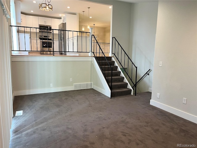 15908 E Flora Pl, Aurora, CO 80013 - unfurnished living room featuring dark colored carpet, a chandelier, baseboards, and recessed lighting