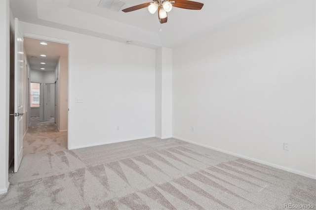 carpeted empty room featuring ceiling fan, baseboards, visible vents, and recessed lighting