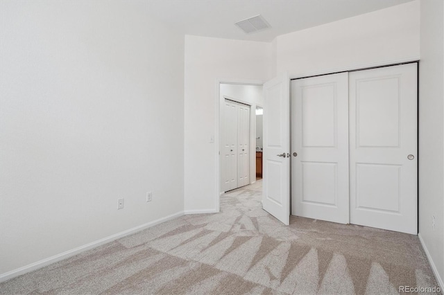 unfurnished bedroom featuring baseboards, visible vents, and carpet flooring