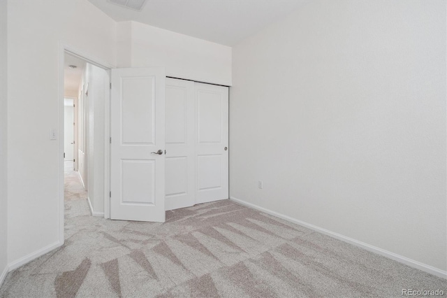 unfurnished bedroom featuring baseboards and carpet