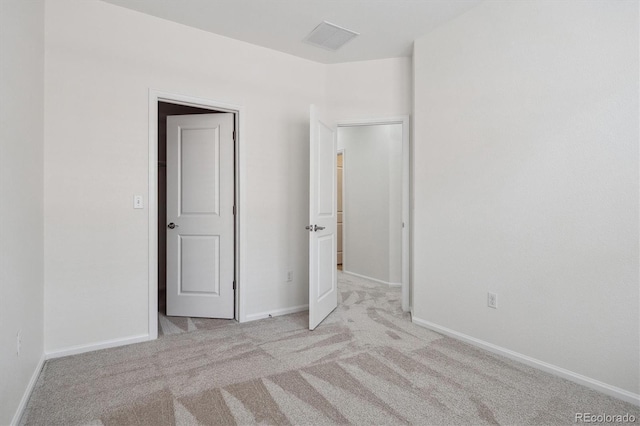 unfurnished bedroom with carpet, visible vents, and baseboards