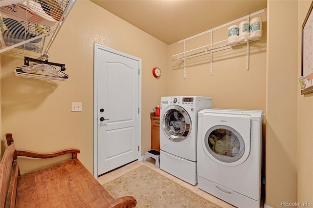 clothes washing area featuring light tile patterned floors, laundry area, and independent washer and dryer