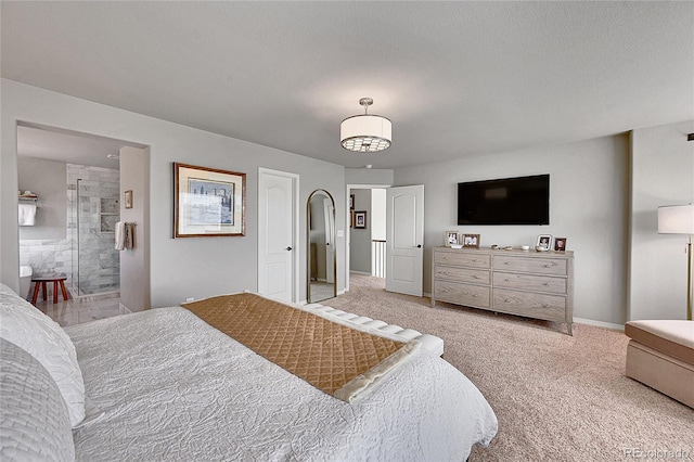 bedroom featuring baseboards, light carpet, and ensuite bath