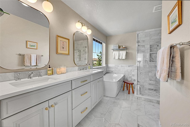 full bath featuring visible vents, a sink, marble finish floor, and a shower stall