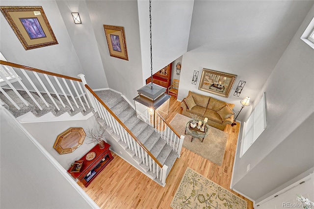 staircase featuring baseboards and wood finished floors