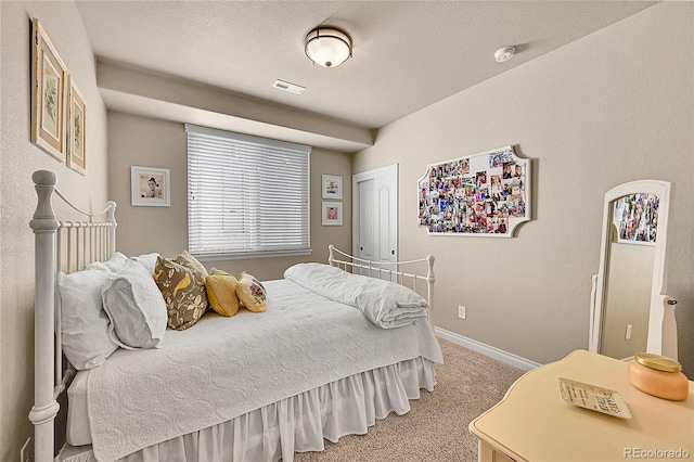 bedroom with carpet flooring, baseboards, and visible vents