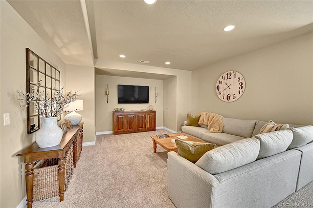 living area featuring a textured ceiling, visible vents, light colored carpet, baseboards, and recessed lighting