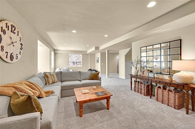 carpeted living area featuring recessed lighting and baseboards