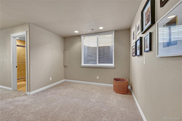 carpeted spare room with recessed lighting, baseboards, visible vents, and a healthy amount of sunlight