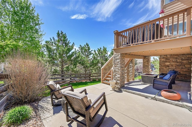 view of patio / terrace with fence, stairs, and outdoor lounge area