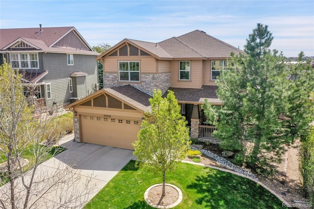 craftsman inspired home with roof with shingles, stone siding, a garage, a front yard, and concrete driveway