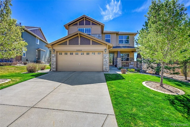 craftsman-style house featuring an attached garage, a front yard, stone siding, and concrete driveway