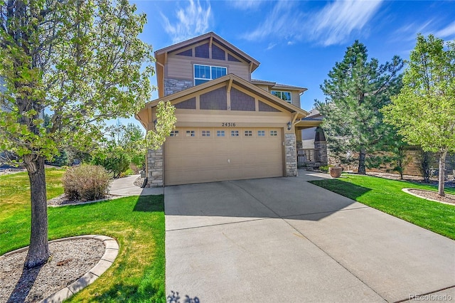 craftsman-style home featuring a front yard, stone siding, and concrete driveway
