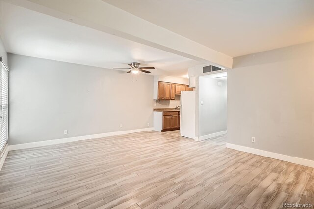 unfurnished living room featuring light wood finished floors, ceiling fan, and baseboards