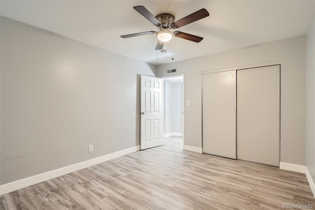 unfurnished bedroom with light wood-style flooring, baseboards, a closet, and ceiling fan